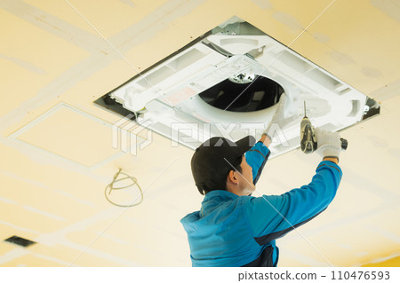Workers inspecting air conditioners 110476593