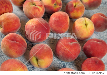 Group of apricots on blue marble like board, closeup photo 110476957