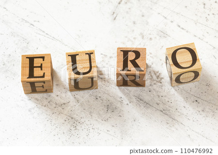 Four wooden cubes with word EURO on white working board Four wooden cubes with word EURO on white working board 110476992