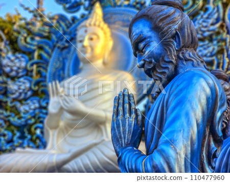 Praying monk statue at Wat Rong Suea Ten Blue temple, Chiang Rai, Thailand Praying monk statue at Wat Rong Suea Ten Blue temple, Chiang Rai, Thailand 110477960