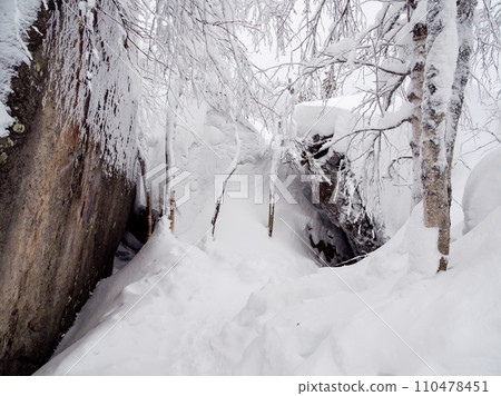 Hiking trail is covered with snow in a white winter veil. 110478451