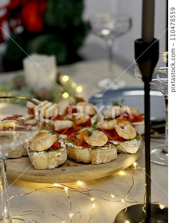 Festive candlelight dinner with shrimp and caviar sandwiches Festive candlelight dinner with shrimp and caviar sandwiches 110478559