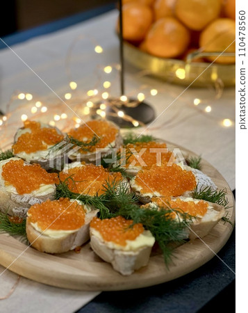 Festive candlelight dinner with shrimp and caviar sandwiches 110478560