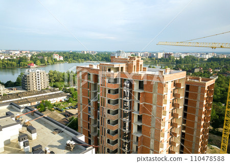 Aerial view of tall residential apartment buildings under construction. Real estate development. Aerial view of tall residential apartment buildings under construction. Real estate development. 110478588