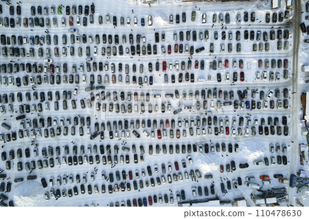 Aerial view of many cars parked for sale and people customers walking on car market or parking lot in winter Aerial view of many cars parked for sale and people customers walking on car market or parking lot in winter 110478630