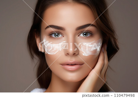 Woman applying moisturizer cream on her face 110479498