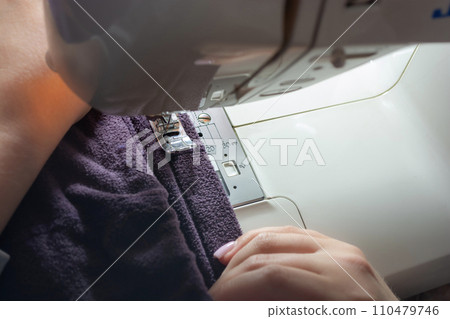 Sewing machine with cloth, close-up. Sewing process Sewing machine with cloth, close-up. Sewing process 110479746