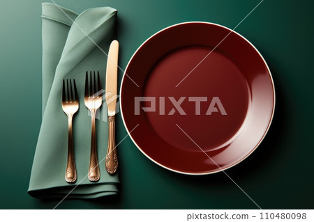 Empty table plate setting on green background. Empty table plate setting on green background. 110480098