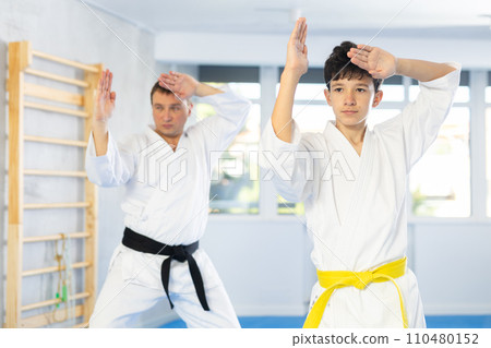 Man and boy teenager train karate technique 110480152