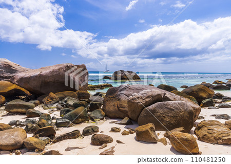 Coastal stones lay on white sand at Beau Vallon beach, Seychelles. Natural landscape 110481250