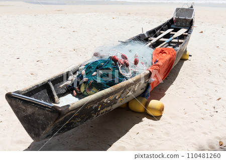 Old boat with fishing nets lays on white sand of Beau Vallon Beach, Seychelles Old boat with fishing nets lays on white sand of Beau Vallon Beach, Seychelles 110481260