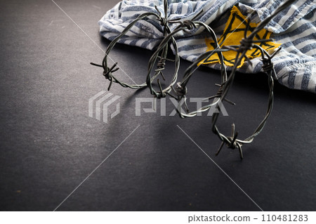 Jewish prisoner with yellow badge on dark background. International Holocaust Remembrance Day Jewish prisoner with yellow badge on dark background. International Holocaust Remembrance Day 110481283