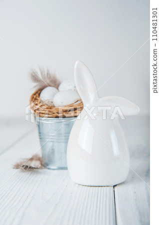 Nest with Easter quail eggs and feathers as concept for festive spring card.. 110481301