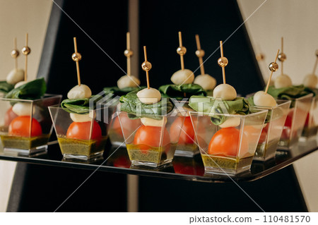 Assortment of delicious snacks on the open buffet festive table in restaurant. Catering plate Assortment of delicious snacks on the open buffet festive table in restaurant. Catering plate 110481570
