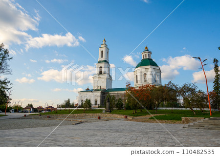 Russian Orthodox church on the stone square against the background of blue sky with clouds 110482535