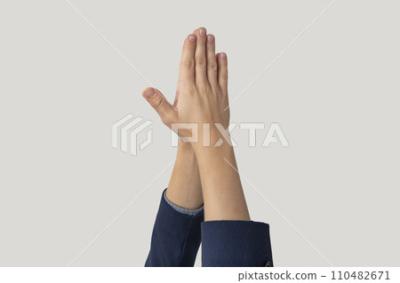 Close up shot of male hands clapping, isolated on grey background 110482671