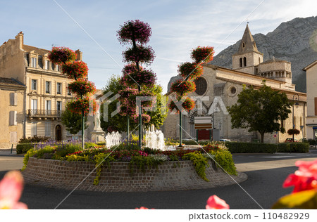 Sisteron cityscape with fountain in blooming flowers and medieval cathedral Sisteron cityscape with fountain in blooming flowers and medieval cathedral 110482929