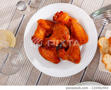 Service plate containing smoked chicken wings with necessary table laying Service plate containing smoked chicken wings with necessary table laying 110482943
