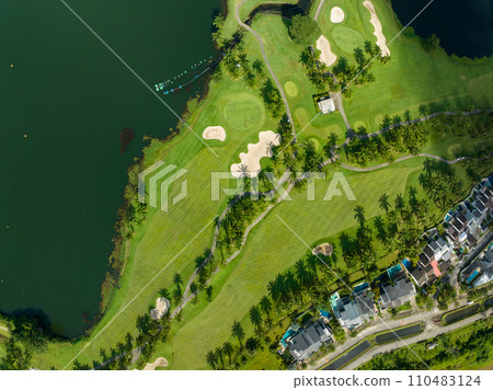 Aerial view of beautiful green golf field fairway and putting green,Top view image for sport background and travel nature background, Amazing green nature view 110483124