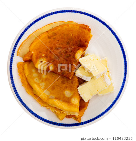 Appetizing delicious pancakes with brie cheese close up Appetizing delicious pancakes with brie cheese close up 110483235