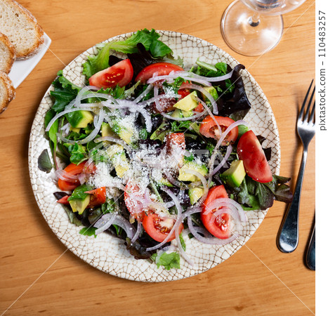 Salad with avocado, tomatoes, onions and cheese Salad with avocado, tomatoes, onions and cheese 110483257