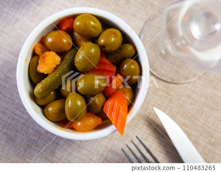 Light snack – oval bowl with pickled vegetables, gherkin and green olives Light snack – oval bowl with pickled vegetables, gherkin and green olives 110483265