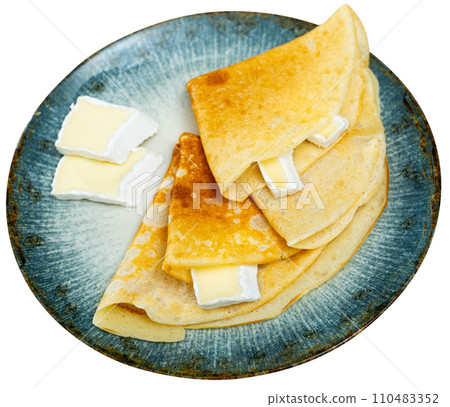 Appetizing delicious pancakes with brie cheese close up Appetizing delicious pancakes with brie cheese close up 110483352