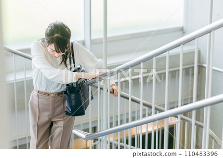 Business woman getting tired climbing stairs Business woman getting tired climbing stairs 110483396