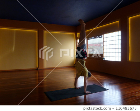 Handstanding inside of a Yoga Studio Handstanding inside of a Yoga Studio 110483673