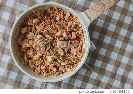 Homemade chicken breast pasta in a pan for high protein diet recipe. 110484332