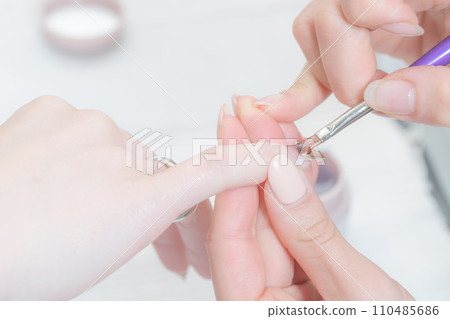Nail salon_Applying top gel Nail salon_Applying top gel 110485686