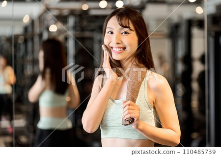 A woman sweating in a gym A woman sweating in a gym 110485739