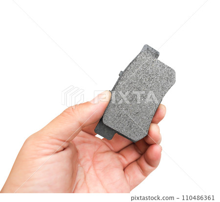 New car brake pads in the hands of a mechanic isolated on white background include clipping path 110486361