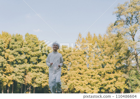 Senior woman slow jogging 110486604