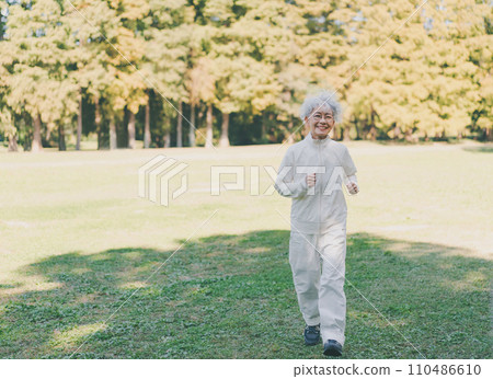 Senior woman slow jogging 110486610