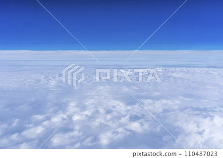 Blue sky and sea of clouds seen from the airplane window Blue sky and sea of clouds seen from the airplane window 110487023