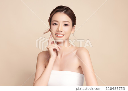 Beautiful young asian woman with clean fresh skin on beige background, Face care, Facial treatment, Cosmetology, beauty and spa, Asian women portrait. 110487753