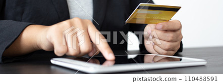 women use Tablet to register online purchases using credit card payments, Convenience in the world of technology and the internet, Shopping online and banking online concept. women use Tablet to register online purchases using credit card payments, Convenience in the world of technology and the internet, Shopping online and banking online concept. 110488591