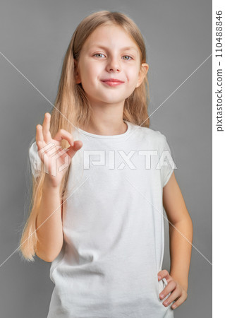 A little blonde girl shows the ok sign A little blonde girl shows the ok sign 110488846