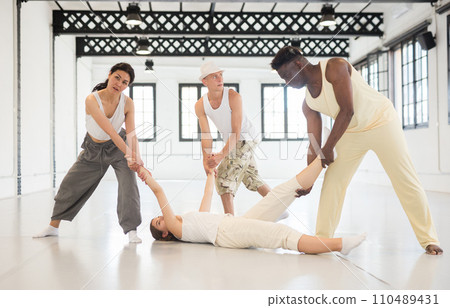 Dancers is doing exercises in class 110489431