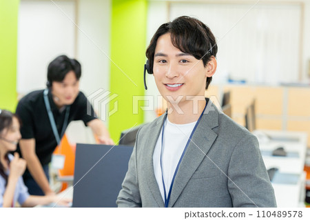 Young male operator speaking on intercom 110489578