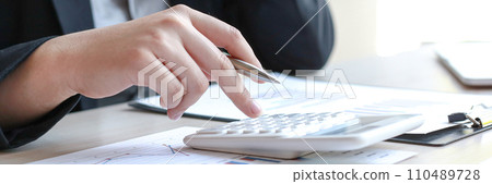Accounting businessmen are calculating income-expenditure and analyzing real estate investment data, Dedicated to the progress and growth of the company, Financial and tax systems concept. 110489728