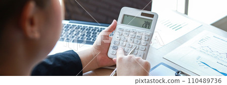 Accounting businessmen are calculating income-expenditure and analyzing real estate investment data, Dedicated to the progress and growth of the company, Financial and tax systems concept. 110489736