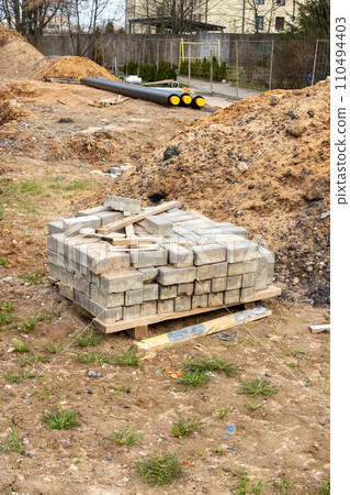 Paving slabs stacked on sand close up 110494403