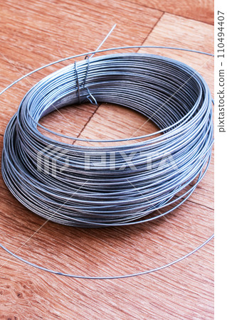 Large coil of wire on the table 110494407