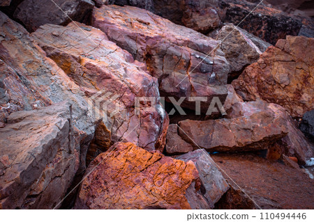 Big seaside rock texture concept photo. Panoramic Mediterranean close up red stones. 110494446