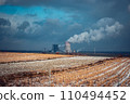 Panoramic view of nuclear power plant with wheat field Nuclear power plant cooling towers, big chimneys 110494452