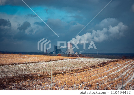 Panoramic view of nuclear power plant with wheat field Nuclear power plant cooling towers, big chimneys 110494452