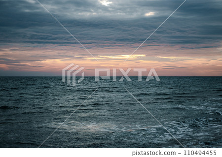 Winter Mediterranean sea waves landscape photo. Peaceful sunset time. Calm waves during vacation. 110494455