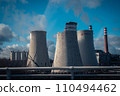 Building a nuclear power plant towers. Big chimneys beside road with partly cloudy sky. 110494462
